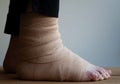 Person with elastic bandage around foot after injury Royalty Free Stock Photo