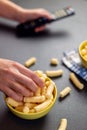 Close up of person with corn puffs, pufuleti or corn crisps Royalty Free Stock Photo