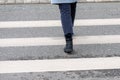 Close-up of person crosses a pedestrian crossing back view Royalty Free Stock Photo