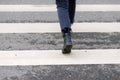 Close-up of person crosses a pedestrian crossing back view Royalty Free Stock Photo