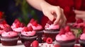 Photo of a person decorating cupcakes up close Royalty Free Stock Photo