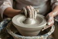 Close up of person forming white raw clay into pottery