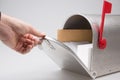 Close-up Of A Person Hand Checking Mailbox in grey background Royalty Free Stock Photo