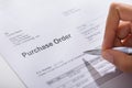 Person Hand Filling A Purchase Order Form Royalty Free Stock Photo