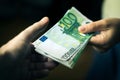 Close-up Of Person Hand Giving Money To Other Hand. Transfer of Euro Banknotes Royalty Free Stock Photo