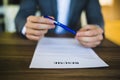 Close-up of Person hand holding curriculum Vitae, resume on table