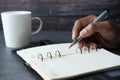 Close up of person hand writing on notepad. Royalty Free Stock Photo