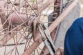 Close-up Of person hands repairs wheel bicycle with pliers