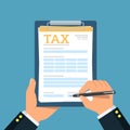 Close-up of person hands with tax clipboard and pen. Business concept of filling tax form. Royalty Free Stock Photo