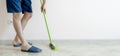 a close up person holding a brush and cleaning the floor with a brush at home wide webn banner