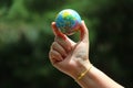 The close up of the person holding the globe Nature background Selectable focus Earth Day concept.