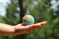 The close up of the person holding the globe Nature background Selectable focus Earth Day concept.
