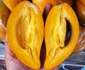 A close up of A person holding a half of a fruit. beautiful picture of soda fruit.