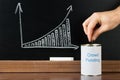 Close-up Of A Person Inserting Coin In Can Royalty Free Stock Photo