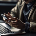 Close Up Of Person At Laptop Using Mobile Phone Royalty Free Stock Photo