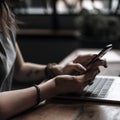 Close Up Of Person At Laptop Using Mobile Phone Royalty Free Stock Photo