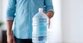 Close up of person with a large water bottle. Light backdrop. Banner. Copy space. Concept of clean drinking water Royalty Free Stock Photo
