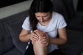 Close-up of a person massaging an injured knee joint. Bruise on the knee. Leg pain