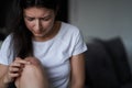 Close-up of a person massaging an injured knee joint. Bruise on the knee. Leg pain