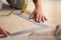 Close up of a seamstress woman who is measuring fabric using rules Royalty Free Stock Photo