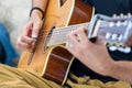 Close up of a person playing an acoustic guitar outdoors Royalty Free Stock Photo