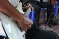 Close-up of a person playing the guitar playing music, conceptual music practice or music lessons.