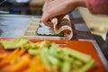 Close up of a person preparing japanese food. Close up of a person making sushi rolls. Close up of a person preparing sushi Royalty Free Stock Photo