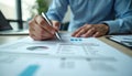 Close-up of person reviewing charts, graphs with pen. Analyzing project timeline, financial reports. Business planning, data