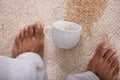 Person`s Feet Standing Near Spilled Coffee