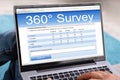 Person Using Laptop Working On 360 Degrees Survey Form Royalty Free Stock Photo