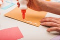 close up person s hand applying white glue paper. High quality photo Royalty Free Stock Photo