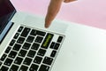 Close up person`s hand finger pushing the `strategy` text on a button of laptop keyboard isolated concept f Royalty Free Stock Photo