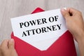Person Holding Power Of Attorney Document In Envelope