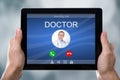 Person`s Hand Holding Tablet With Doctor`s Incoming Call