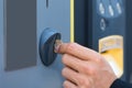 Person`s Hand Inserting Coin At Parking Meter