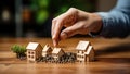 Close-up Of Person\'s Hand and Miniature House On Table