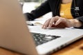 Close-up Person`s hand operating a laptop touchpad and there is a graphic showing people, folder and globe icons, showing a Royalty Free Stock Photo