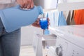 Person Pouring Detergent In Lid Royalty Free Stock Photo