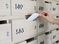 Close-up of person`s hand . hand removing a letter from mailbox in the entrance hall of an apartment building Royalty Free Stock Photo