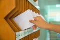 Close-up of person`s hand removing letter from mailbox Royalty Free Stock Photo