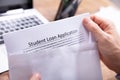 Person Removing Student Loan Application Form From Envelope Royalty Free Stock Photo