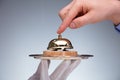 Person`s Hand Ringing Service Bell Hold By Waiter Royalty Free Stock Photo