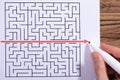 Person Solving Maze Puzzle With Red Marker Royalty Free Stock Photo