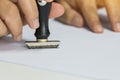 Close-up Of Person`s Hand Stamping On Approved Application Form or Notary public in office stamping documents for signing approva Royalty Free Stock Photo