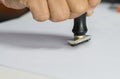 Close-up Of Person`s Hand Stamping On Approved Application Form or Notary public in office stamping documents for signing approva Royalty Free Stock Photo