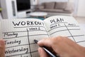 Person Writing Workout Plan In Notebook Royalty Free Stock Photo