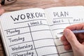 Person Writing Workout Plan In Notebook Royalty Free Stock Photo