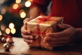 A close-up of a person\'s hands eagerly tearing open a beautifully wrapped Christmas gift Royalty Free Stock Photo