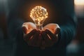 A close-up of a person\'s hands holding a glowing brain shaped light bulb, representing innovative ideas