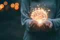 A close-up of a person\'s hands holding a glowing brain shaped light bulb, representing innovative ideas